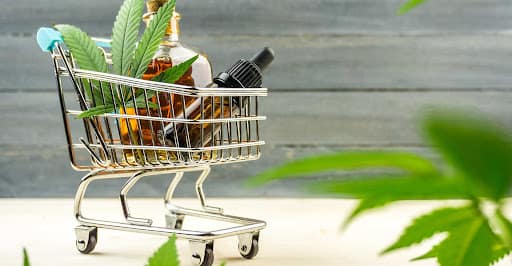 Supermarket Trolley With Marijuana Leafs And Medical Cannabis Oil Cbd